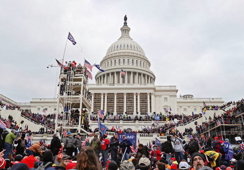 A mob of Trump supporters climb scaffoldings and take to the steps of the U.S. Capitol building in Washington D.C. on Jan. 6, 2021. Rioters breached the building following a rally as Congress was preparing to certify President-elect Joe Biden’s victory.