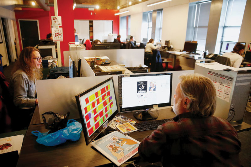Pittsburgh City Paper staff members at work in their downtown Pittsburgh office. Pictured are graphic designer Jeff Schreckengost (left) and director of operations Kevin Shepherd.