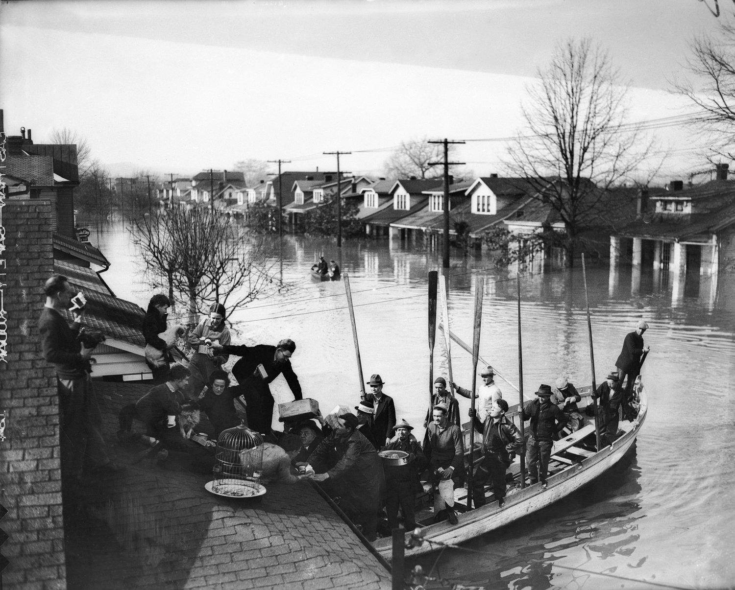 Louisville residents and their pets are rescued in this photo taken during the Great Flood of 1937. (UofL Photo Archives / Barry Bingham Jr. Courier-Journal Photo Collection)