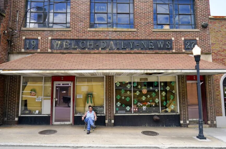 Missy Nester, owner of The Welch News, sits in front of the closed office in Welch, W.Va., on May 31, 2023. The weekly publication became another casualty of the national newspaper crisis. (AP Photo/Chris Carlson)